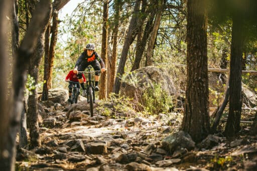 Two mountain bike riders riding over Beechworth Mountain Bike Park's granite rock gardens