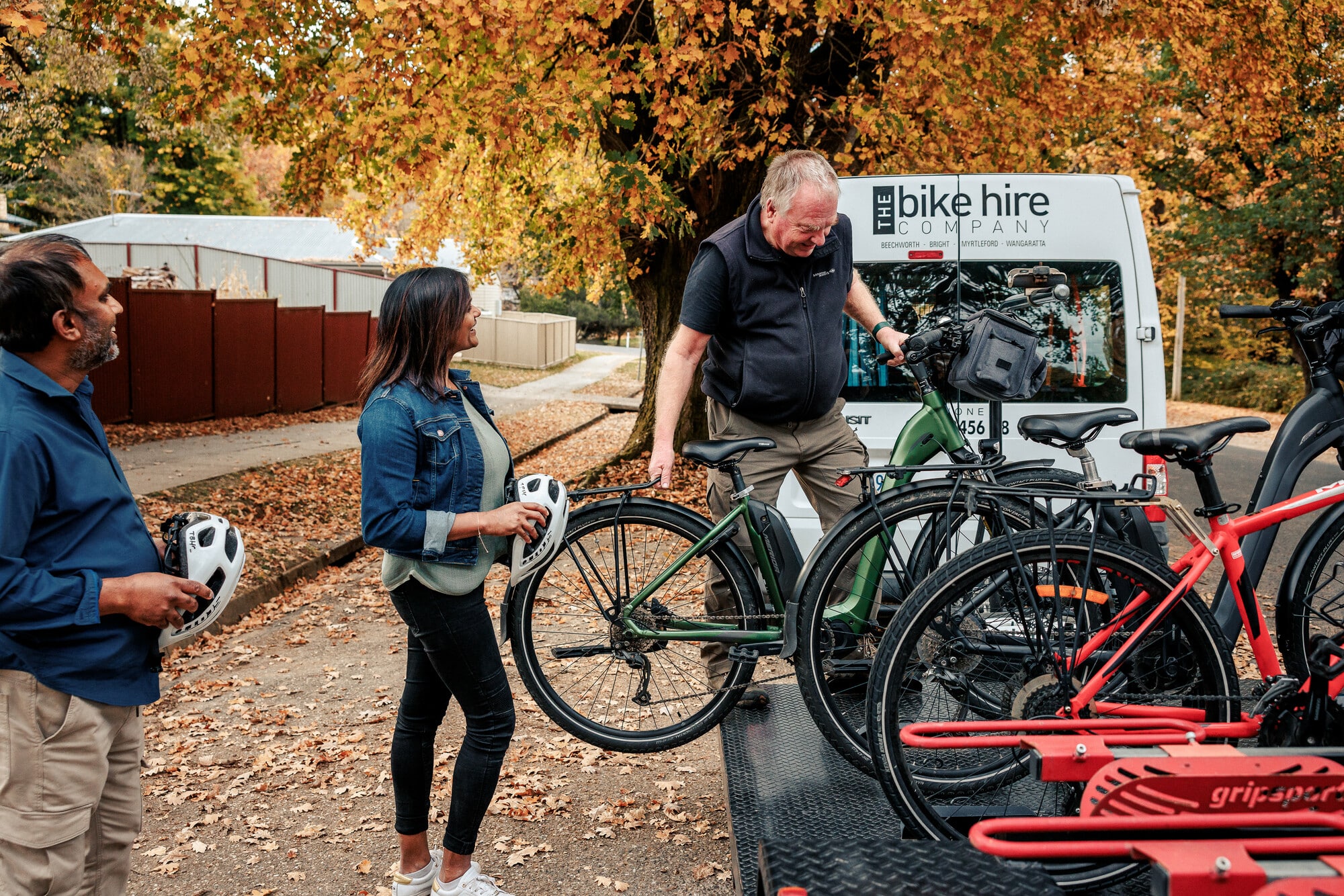 Couple having bikes loaded in Yackandandah on a pre-booked bike shuttle on the Yackandandah to Beechworth Rail Trail's